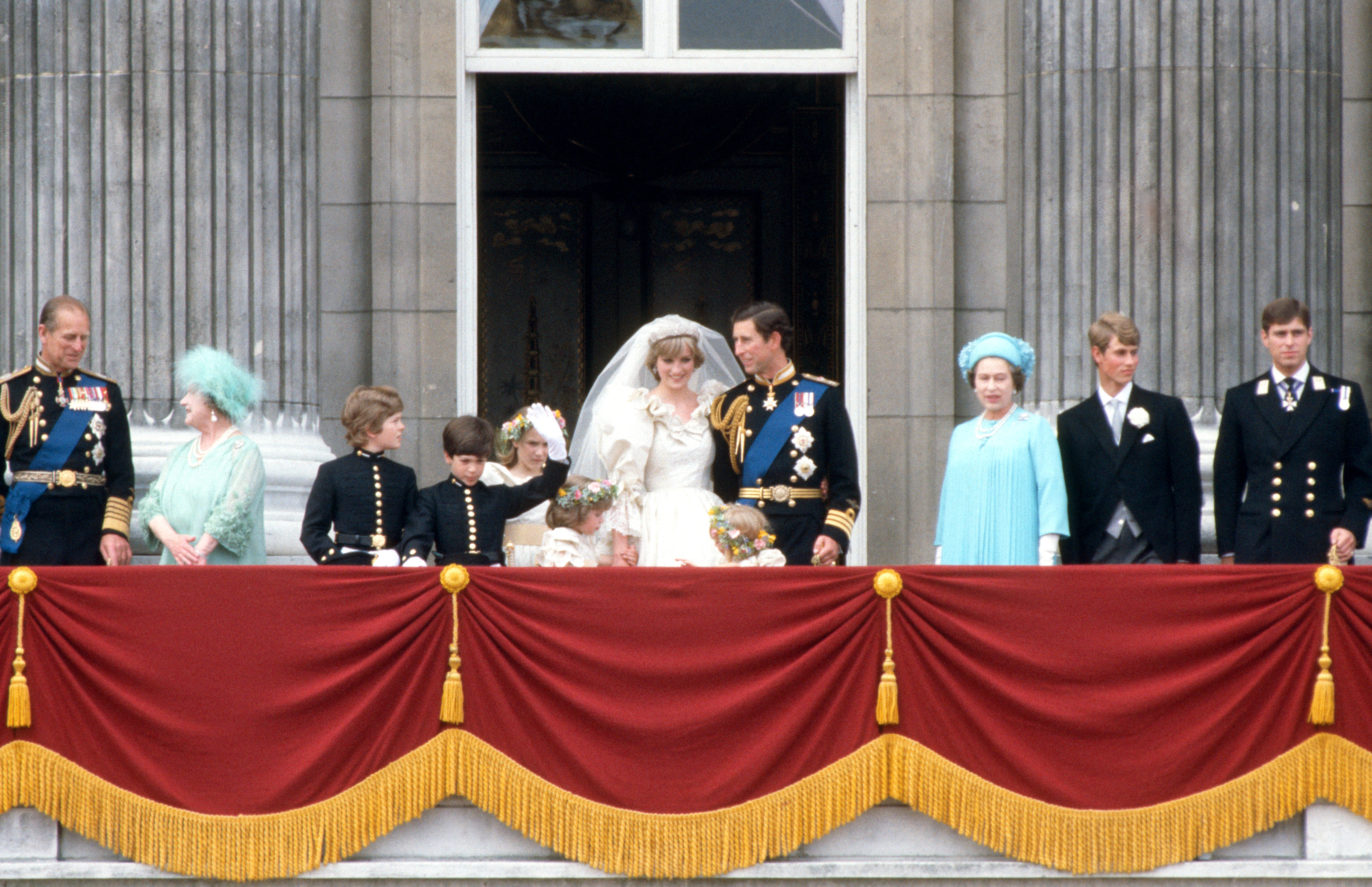 Prince Charles, Prince of Wales and Diana, Princess of Wales, seen on the balcony at Buckingham Palace following their wedding on July 29, 1981. They are joined by, from left: Prince Philip, Duke of Edinburgh, Queen Elizabeth the Queen Mother, Pageboys Lord Nicholas Windsor and Edward Van Cutsum, Bridemaids Sarah Jane Gaselee, Clementine Hambro and Catherine Cameron, Queen Elizabeth II, Prince Edward and Prince Andrew.