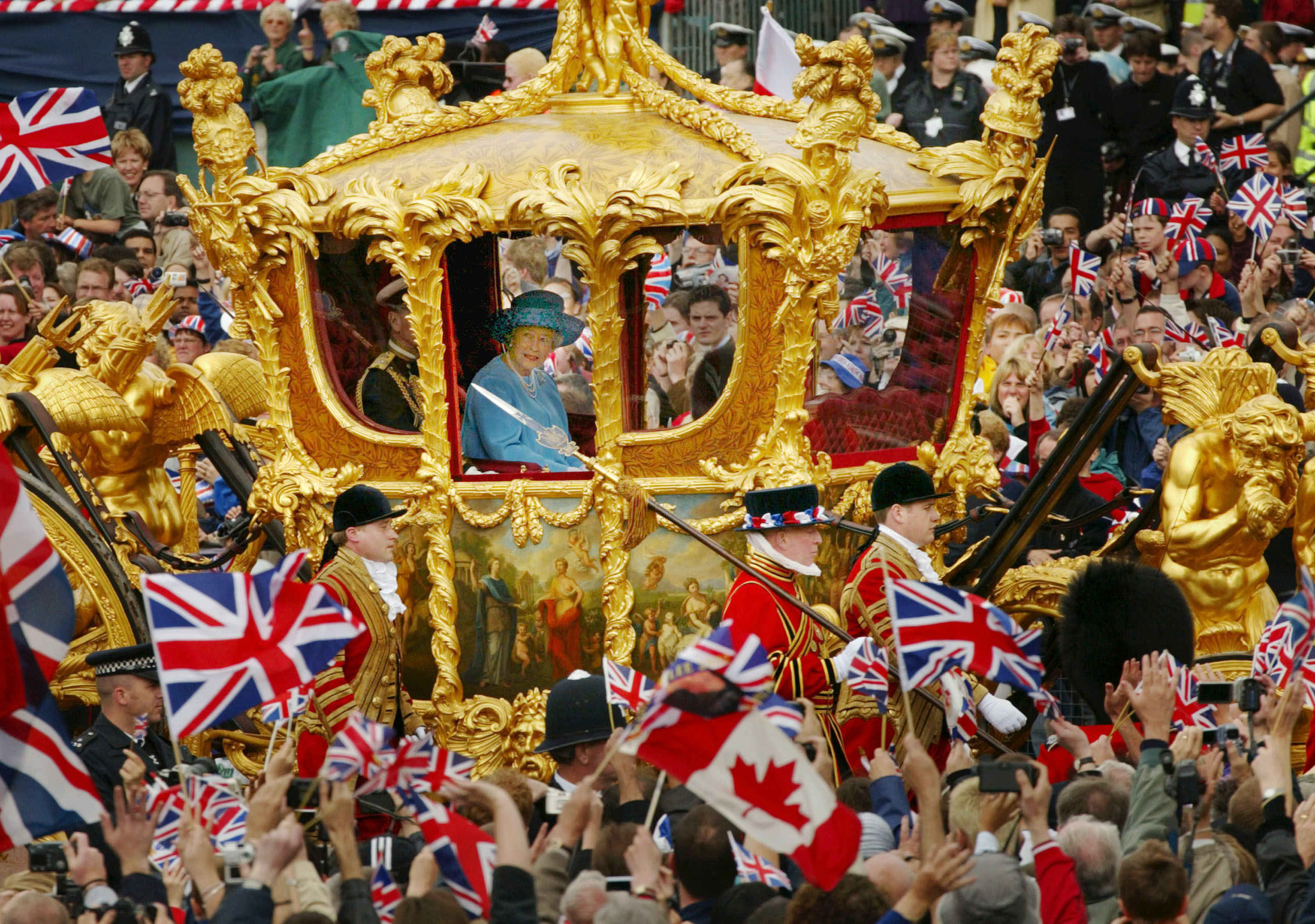 Britain’s Queen Elizabeth and Prince Philip ride in the Golden State Carriage at the head of a parade from Buckingham Palace to St Paul’s Cathedral celebrating the Queen’s Golden Jubilee, or the 50th anniversary of her monarchy, June 4, 2002, along The Mall in London.