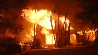 Fire engulfs a home as the Eaton Fire moves through the area on Jan. 8, 2025, in Altadena, California.