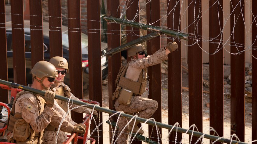 U.S. Marines install barbed wire along the border fence Friday, Jan. 31, 2025, in San Diego. (AP Photo/Jae C. Hong)
