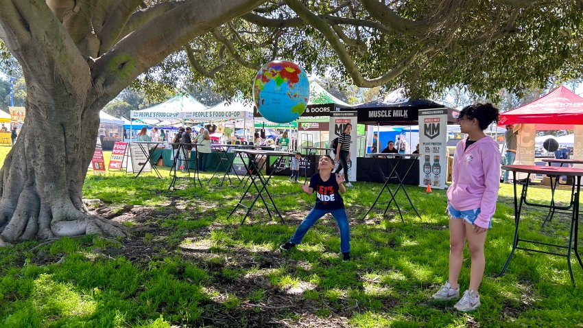 Seven-year-old Darrin Mitchell plays with an Earth beach ball, April 19, 2025, in Balboa Park.