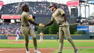 DENVER, CO – MAY 09: Fernando Tatis Jr. #23 of the San Diego Padres high-fives Jackson Merrill #3 after scoring a run in the top of the first inning during the game between the San Diego Padres and the Colorado Rockies at Coors Field on Friday, May 9, 2025 in Denver, Colorado. (Photo by Dustin Bradford/MLB Photos via Getty Images)